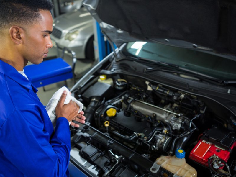 attentive-mechanic-servicing-car